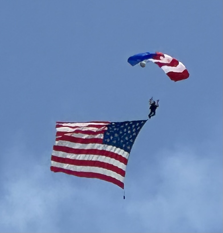 American Flag and Parachute above Oshkosh.